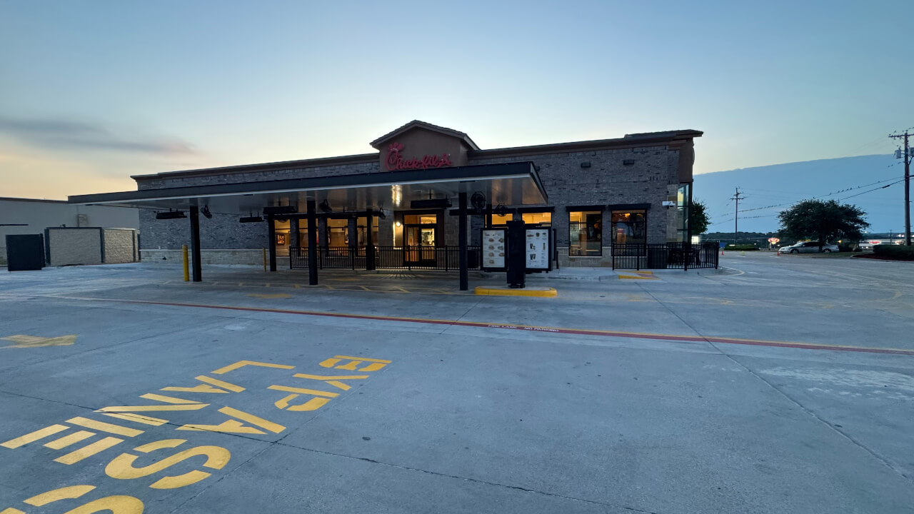 Restaurant drive-thru entrance at dusk.