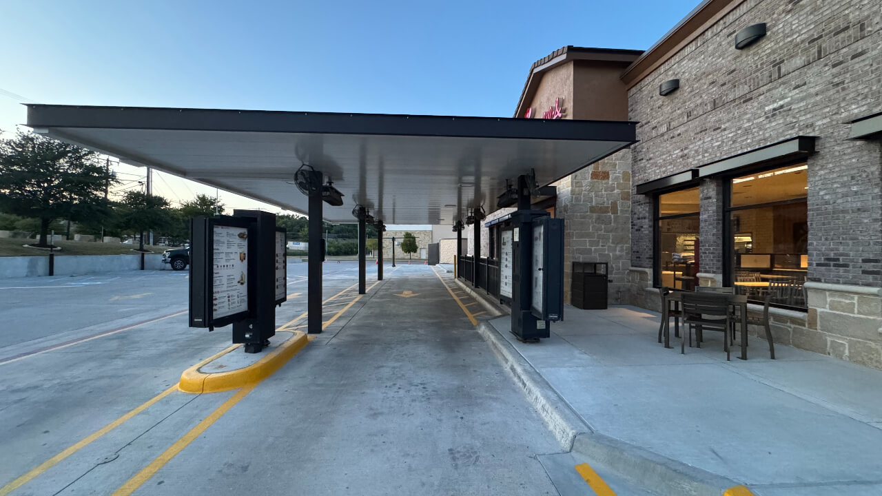 Drive-thru lane beside a restaurant building.