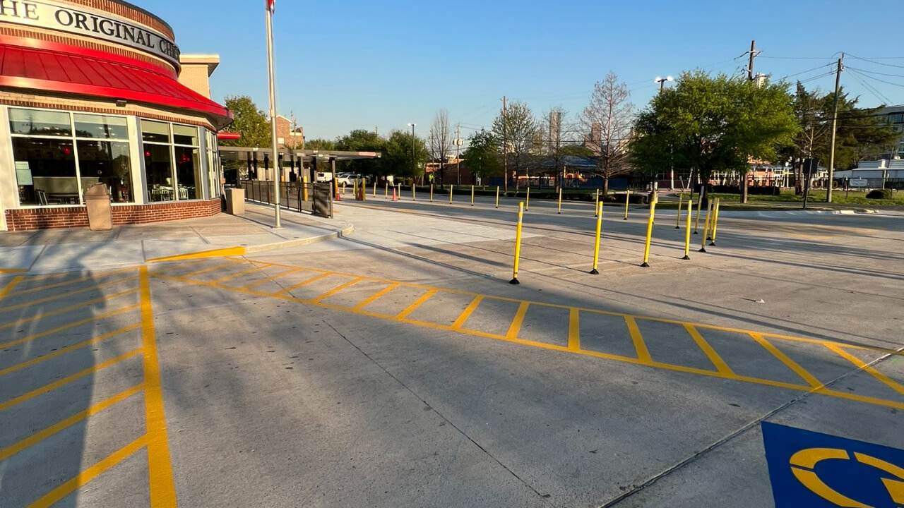 Empty restaurant parking lot with yellow lines.