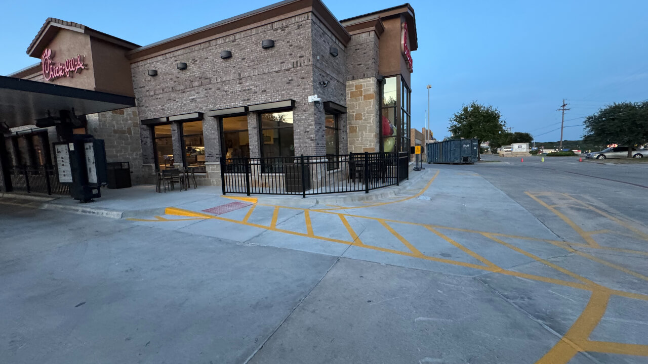 Restaurant exterior with parking lot view.