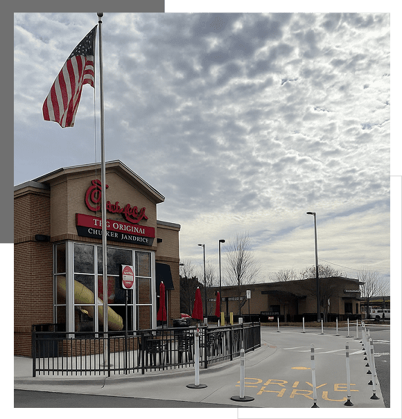 Chick-fil-A restaurant with American flag flying overhead on a cloudy day.