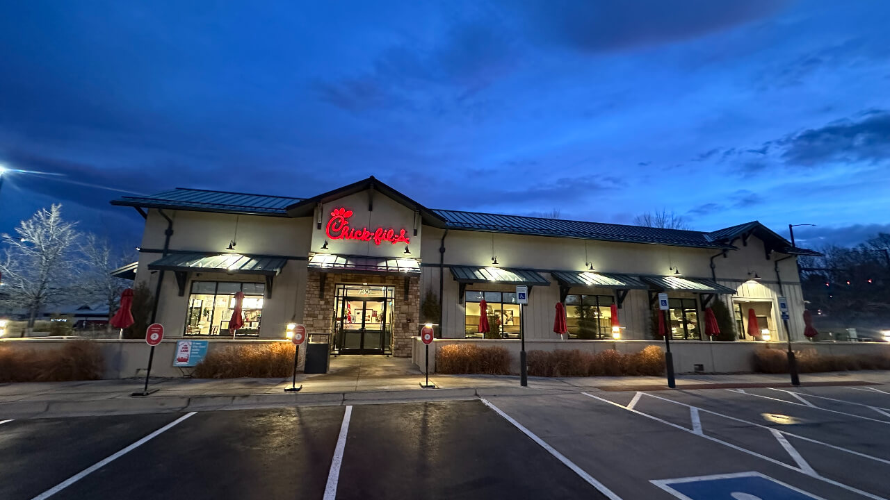 Chick-fil-A restaurant exterior at dusk.