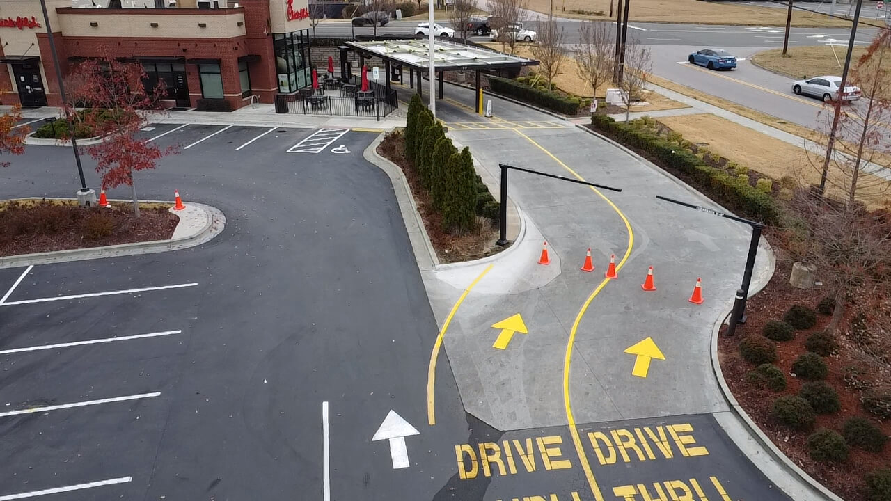 Drive-thru with directional arrows and cones.