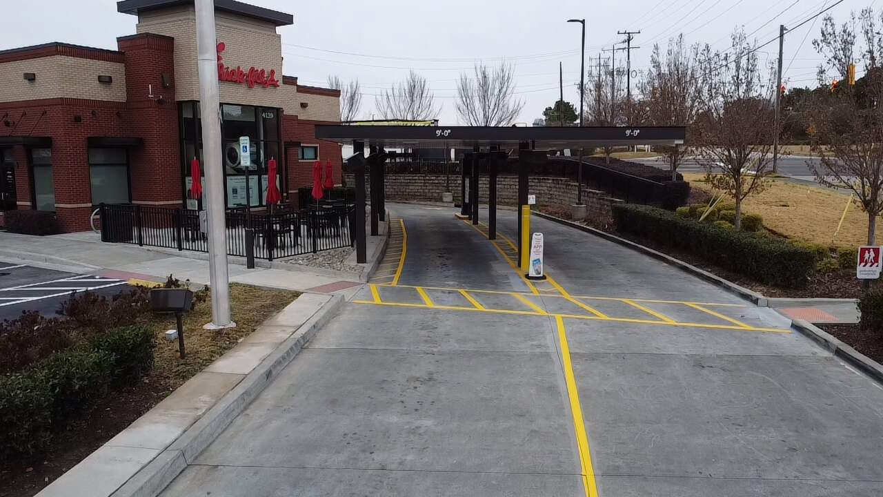 Empty fast-food drive-thru lane and building.