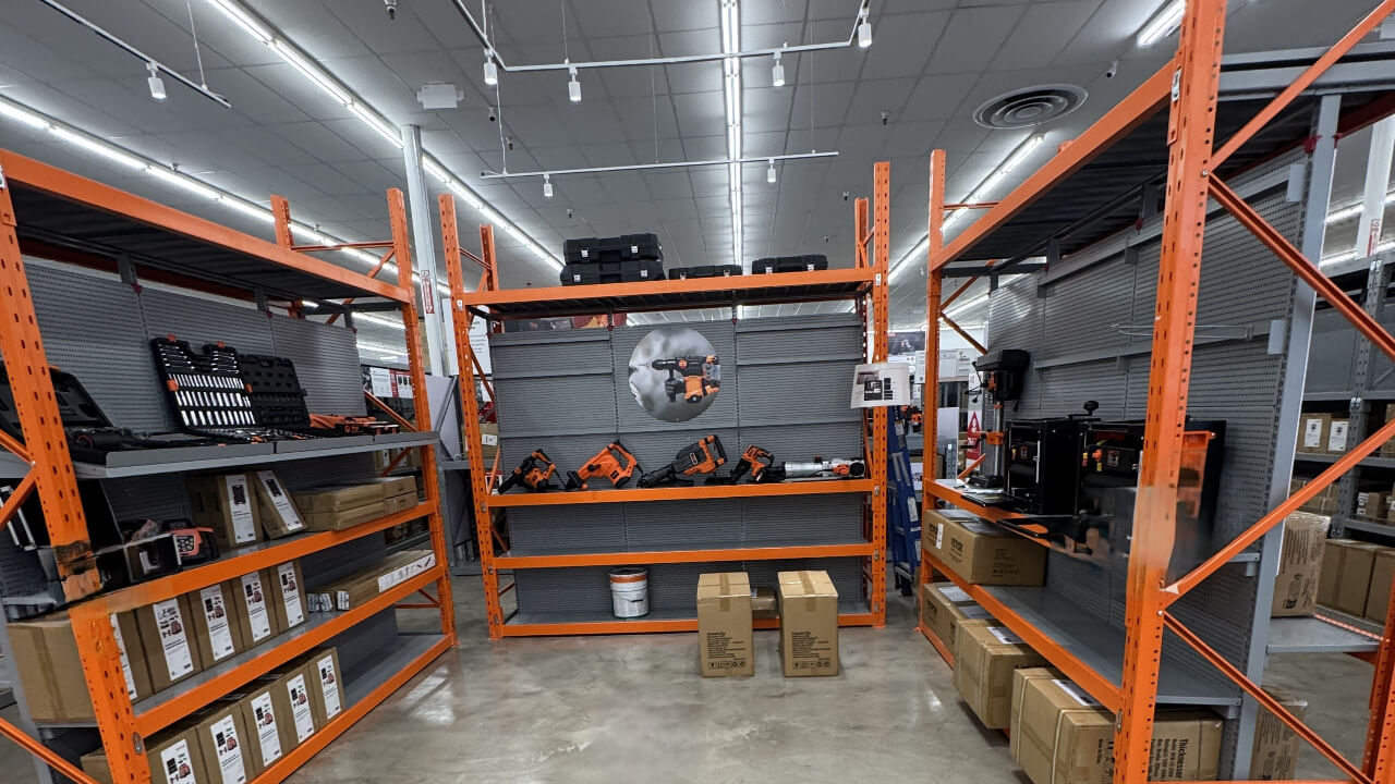 Warehouse shelves with tools and boxes displayed.