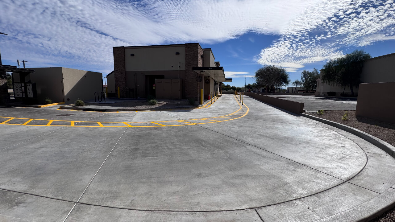 Empty drive-thru with clear blue sky.