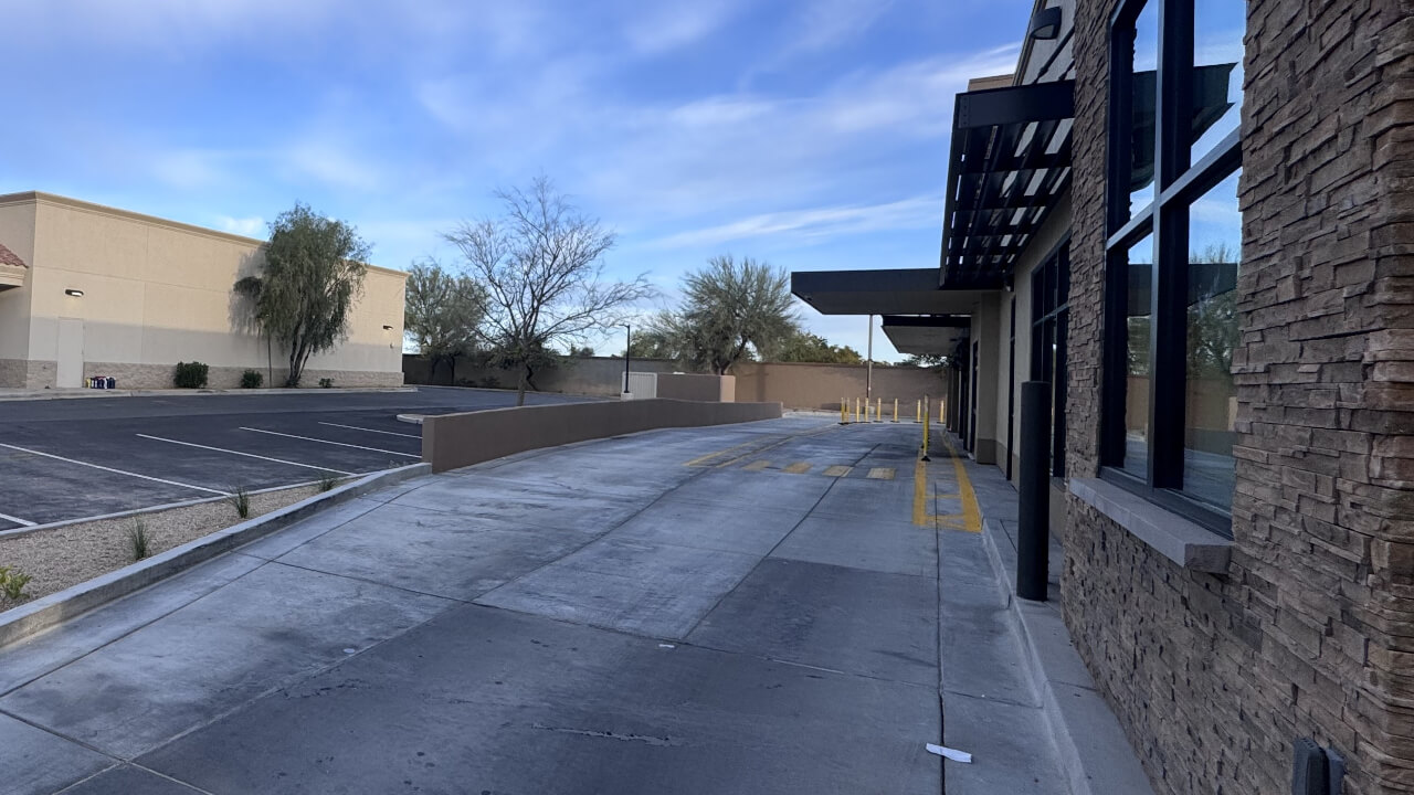Empty parking lot beside a modern building.
